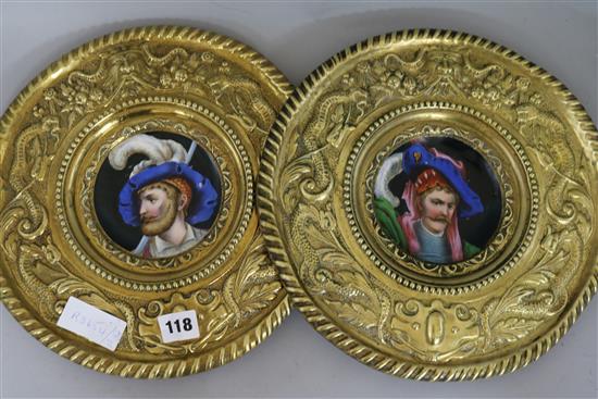 A pair of brass and ceramic plaques